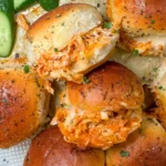 Spicy Buffalo Chicken Sliders served on a platter with melted cheese and Buffalo sauce drizzle.