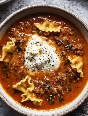 Mouthwatering One Pot Lasagna Soup in a bowl with melted cheese and basil garnish