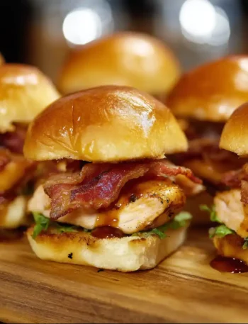 Maple Chicken & Beef Bacon Sliders served on toasted buns with maple syrup glaze and crispy bacon